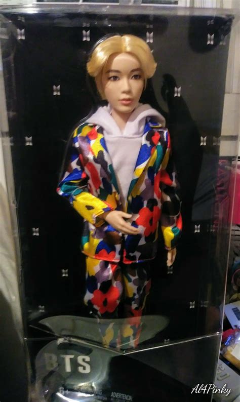 A Mannequin Wearing A Colorful Suit In A Display Case