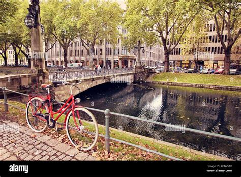 Red Bike At The Historic City Canal Of The Famous Shopping Boulevard