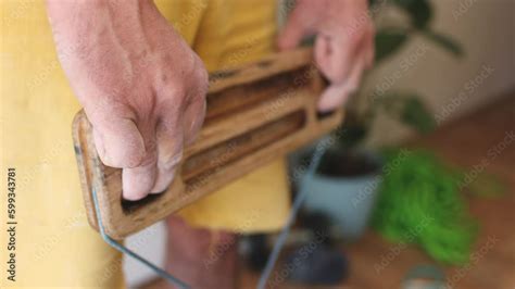 strong male hand of a rock climber holds a board for training finger ...