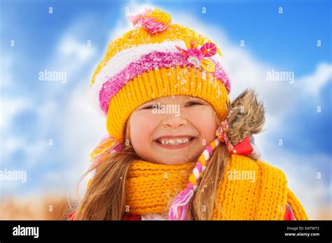 Face Portrait Of Happy Smiling Girl On Winter Day Wearing Yellow