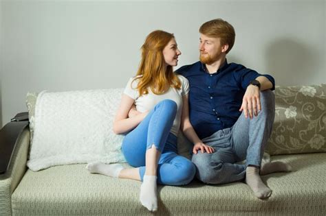 Premium Photo Beautiful Couple Man And Woman Sitting On The Sofa At Home