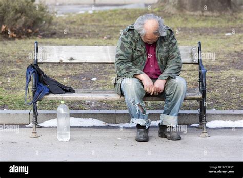 Homeless Man Sleeping On A Bench Stock Photo Alamy