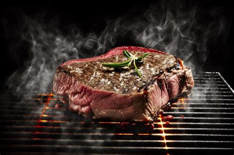 Beef Steak On Grill With Rosemary Pepper And Salt Barbecue Meat On