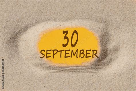 September 30. 30th day of the month, calendar date. Hole in sand ...