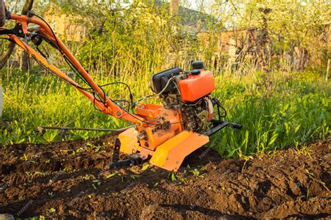 Premium Photo A Small Agricultural Tractor Plows The Ground The Work