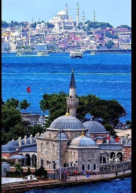 An Old Building With A Dome On The Top In Front Of Some Water And Buildings