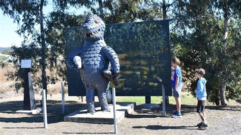 Sculpture Of A Bunyip In Front Of A Mural At The Bunyip Statue In