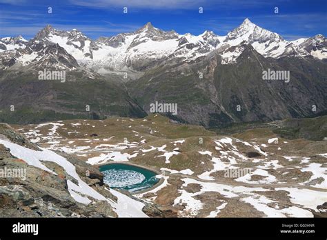 Alpine lake and mountains with snow, Switzerland Stock Photo - Alamy