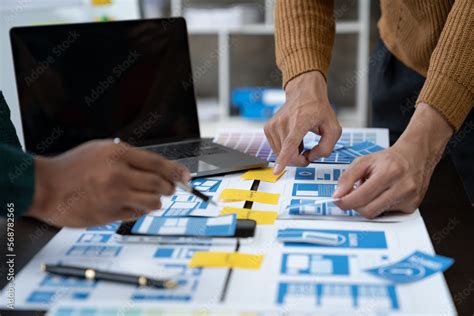 Ux Developers And Ui Designers Data Researchers Brainstorm On Tabletop