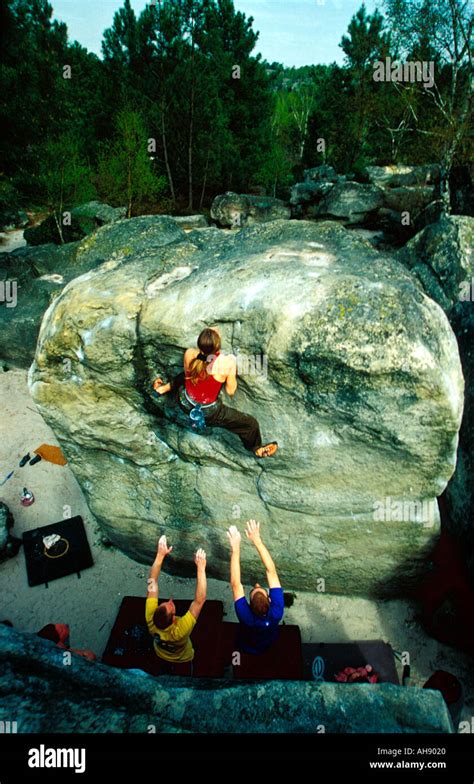 Lucy Creamer on a high boulder problem in Fontainbleau France Stock ...