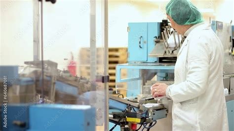 Pharmaceutical Female Production Line Worker Controls The Capsule