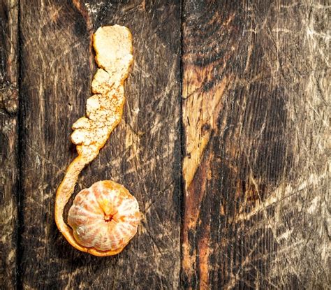 Premium Photo Ripe Peeled Mandarin On Wooden Table