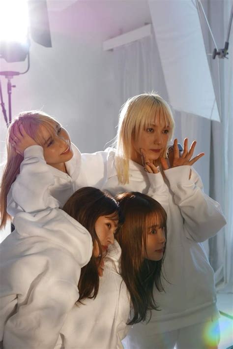 Three Women In White Outfits Posing For The Camera