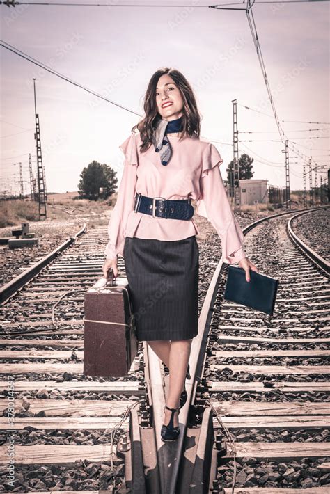 Mujer andando por las vías del tren Stock Photo Adobe Stock