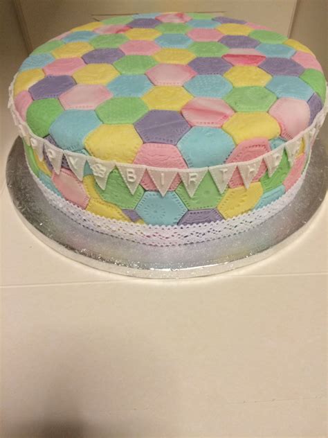 A Multicolored Cake Sitting On Top Of A Counter