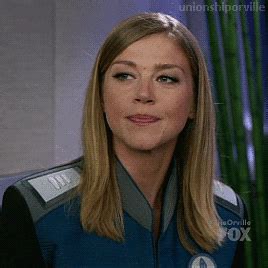 A Woman With Blonde Hair Wearing A Star Trek Uniform