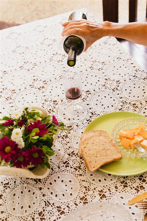 A Person Pouring Red Liquid into a Glass · Free Stock Photo