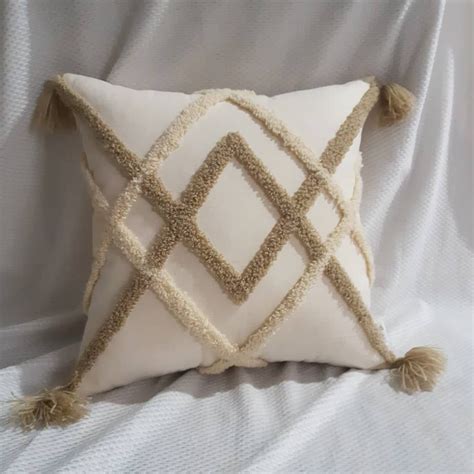 A White Pillow With Tassels On It