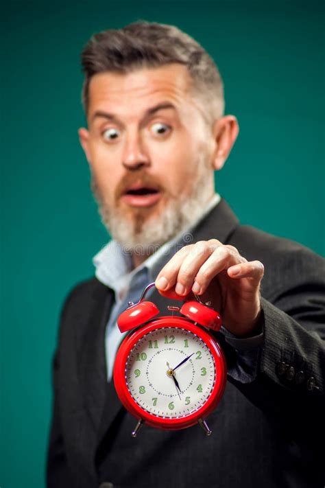 Surprised Bearded Businessman Holding Alarm Clock Time Management