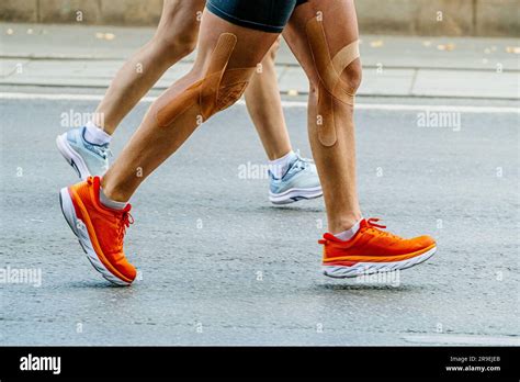 Close Up Legs Couple Runners Man And Woman Running Marathon Race