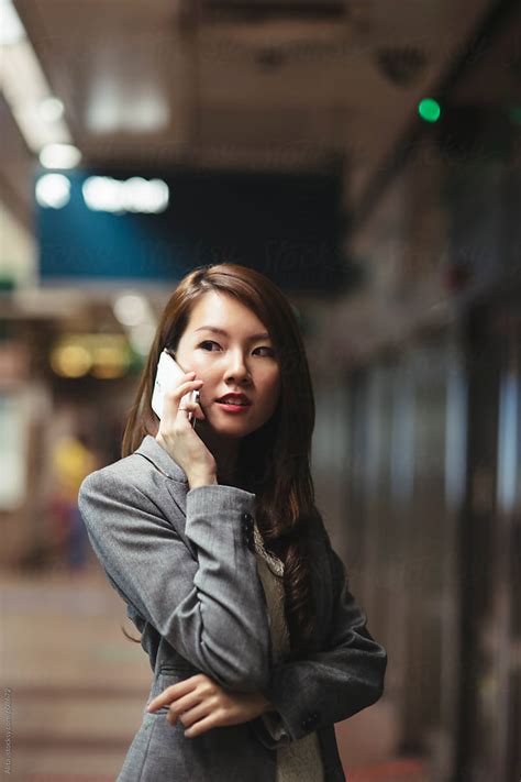 Asian Businesswoman Making Phone Call At Underground Train Station By