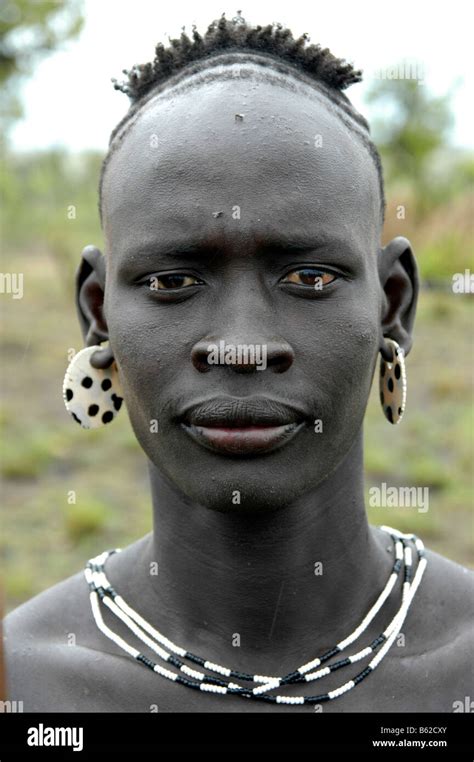 Portrait Of A Man Of The Mursi Tribe With A Particular Hairstyle Near