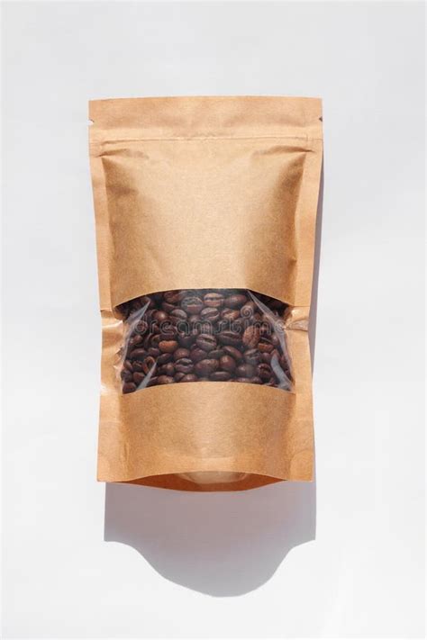 Brown Kraft Paper Pouch Bags With Coffee Beans Top View With Shadow On