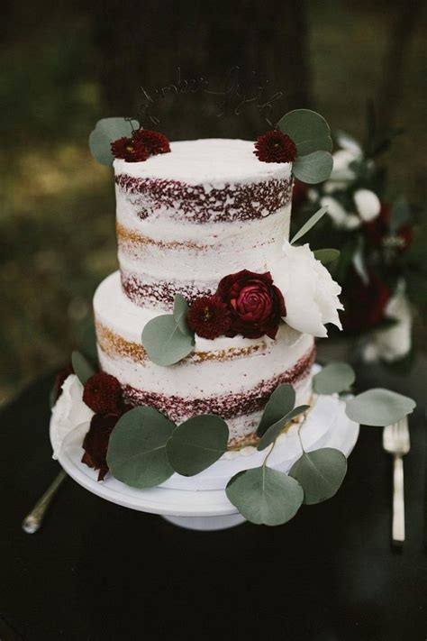 Semi naked wedding cake with burgundy flowers