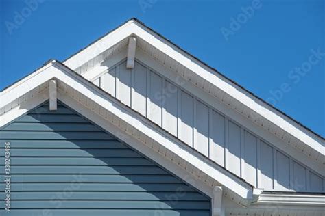 Double Gable With White Decorative Corbel Bracket Brace On A Triangle Gable Roof White