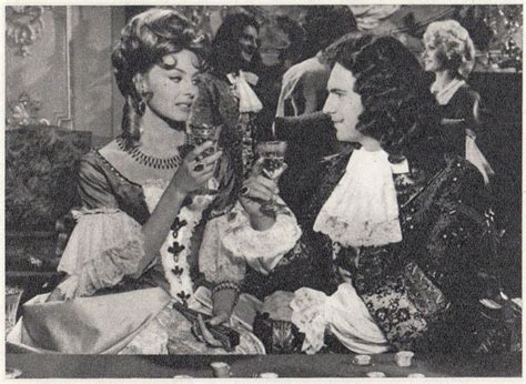 An Old Black And White Photo Of Two Women Dressed In Period Clothing