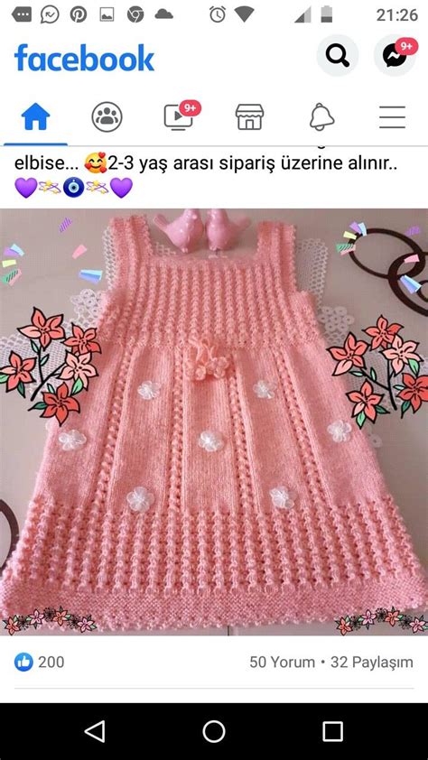 A Knitted Pink Sweater With Flowers On The Front And Bottom Is