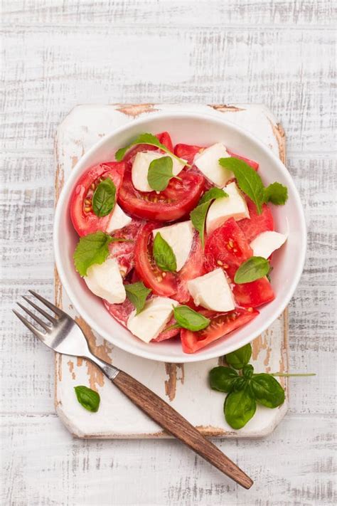 Delicious Caprese Salad With Ripe Tomatoes And Mozzarella Cheese With