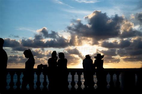 Silhouette Of Tourist People Enjoying The Sunset At Porto Da Barra In