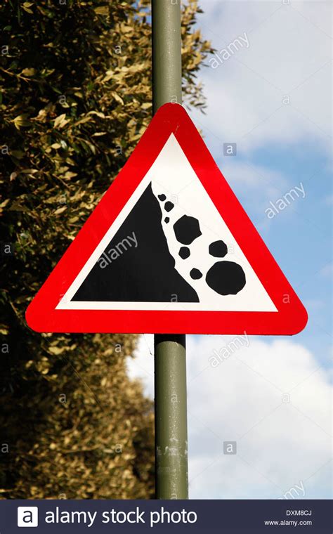 A Red Triangle Sign Warning Of The Danger From Falling Rocks From Stock