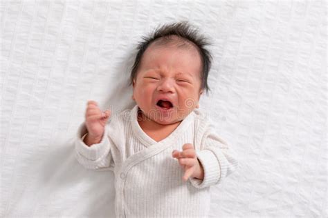 Niño Recién Nacido Llorando Y Enojado Tendido En Una Cama Blanca En El