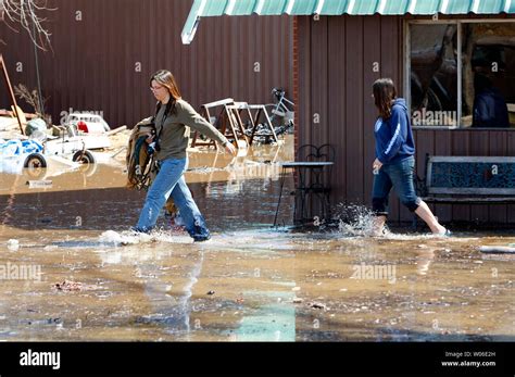 Women Walk Through Flood Waters From The Rising Meramec River As They