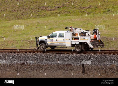 Hi-rail truck on train tracks Stock Photo - Alamy