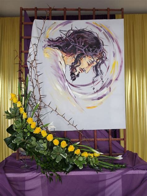 A Painting And Flowers On A Purple Table Cloth