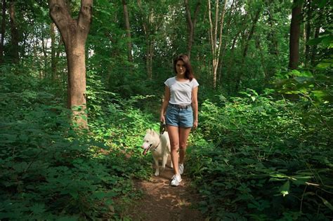 Premium Photo | Beautiful woman walking her dog