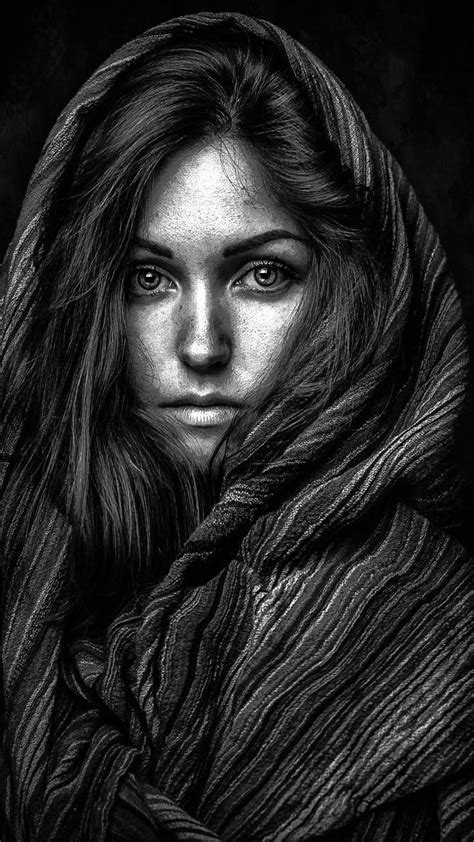 A Black And White Photo Of A Woman Wrapped In A Blanket