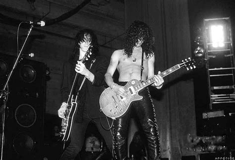 Black And White Photograph Of Two Men Playing Guitar In Front Of