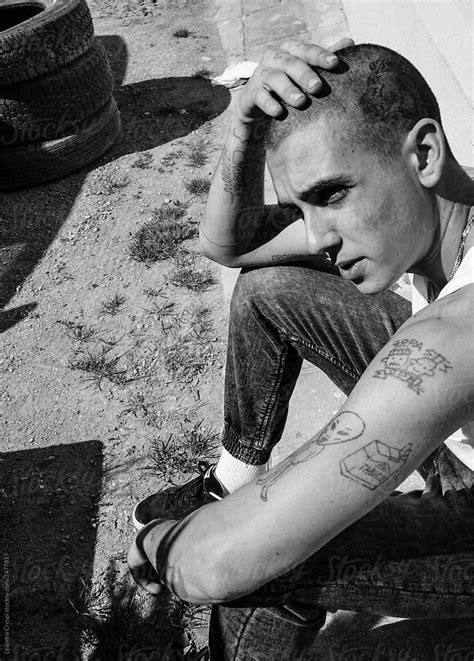 cool tattooed young badass man street fashion portrait  black