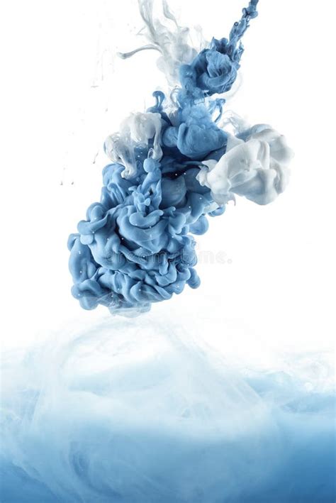 Close Up View Of Mixing Of Blue And White Paint Splashes Stock Photo