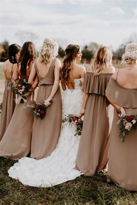 A Group Of Bridesmaids In Brown Dresses Looking At Each Other While