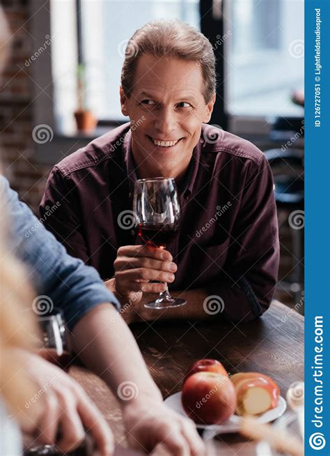 Handsome Smiling Man Drinking Red Wine And Looking Away Stock Image