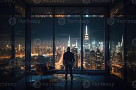 Businessman standing near window with view at night city. 23598955 ...