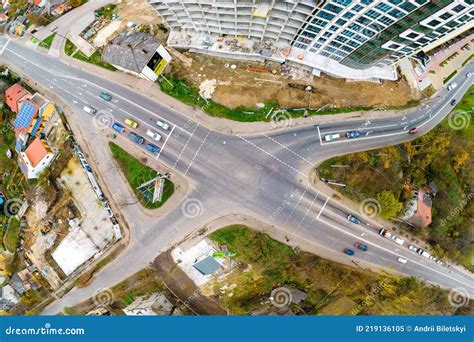 Top Down Aerial View Of Busy Street Intersection With Moving Cars