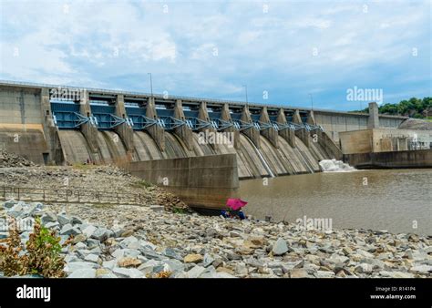 Two Fishermen Cast Their Lines Below The Dam Stock Photo Alamy