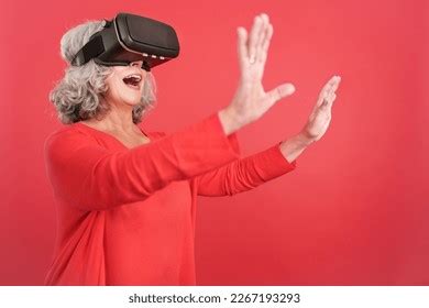 Mature Woman Gesturing While Using Virtual Stock Photo
