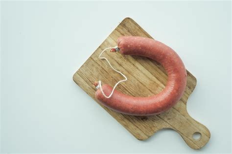 Premium Photo Raw Fresh Sausage And Vegetables On Table